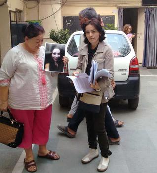 Mother of Shakhnoza Shukurova and her sister showing her photo to media 